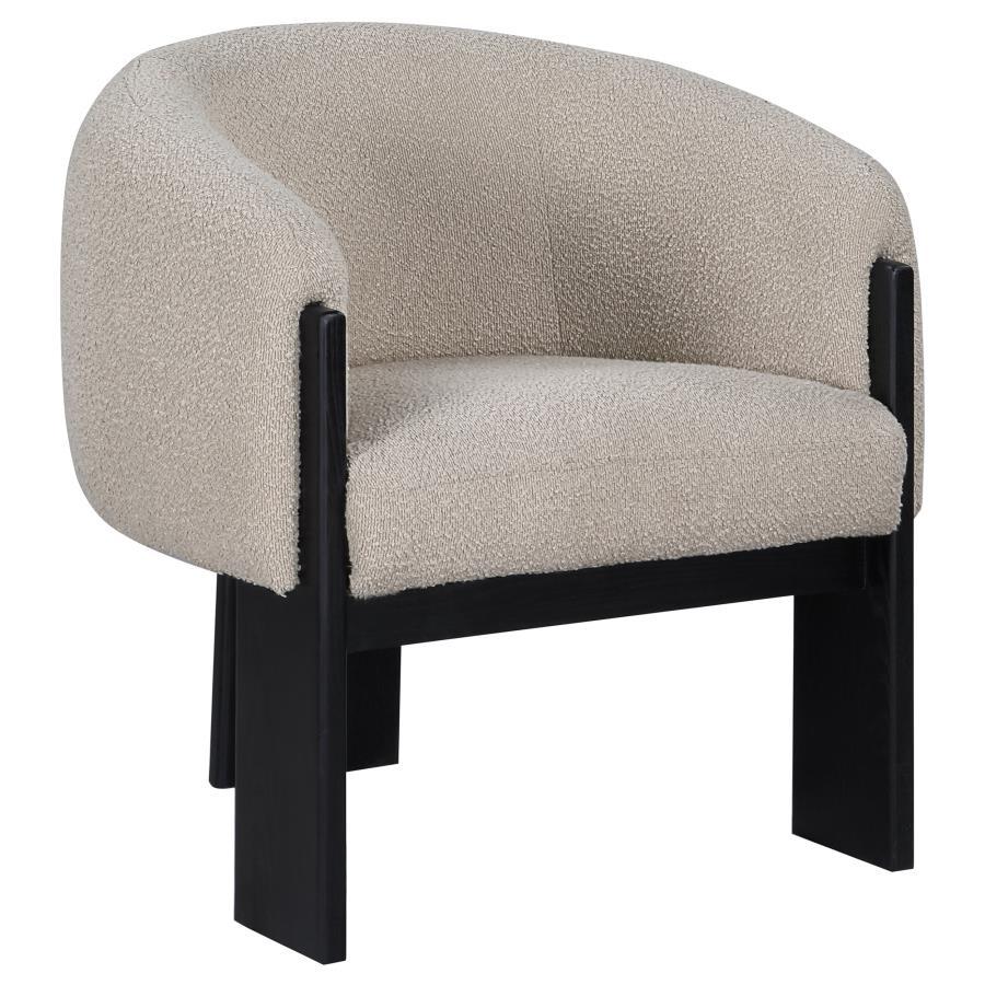 Bring updated style and sophistication to your living room or den with a modern accent armchair. It boasts an inviting rounded silhouette with sloping arms. Three legs in a black finish add a sculptural sensibility. Textured boucle upholstery creates rich