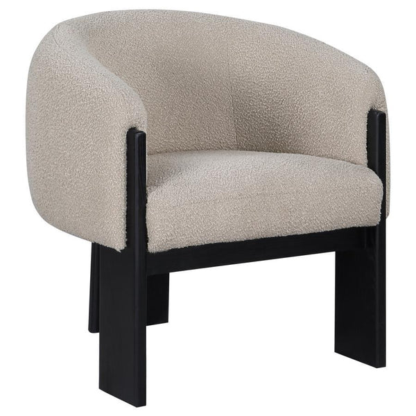 Bring updated style and sophistication to your living room or den with a modern accent armchair. It boasts an inviting rounded silhouette with sloping arms. Three legs in a black finish add a sculptural sensibility. Textured boucle upholstery creates rich