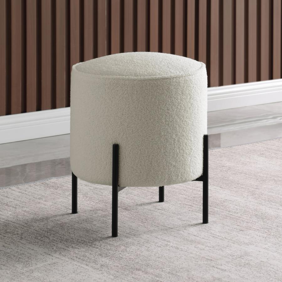 Minimal and playful, this modern ottoman offers extra seating in a contemporary style home. Wrapped in soft, plush upholstery, it provides a bright, airy touch to any space. Supported by slim, rod-like metal legs in a matte finish, this round ottoman cont