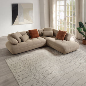 Discover unparalleled modern comfort with the Carrick sectional sofa. Draped in beige sandwich mesh fabric with a distinctive 3D texture, this sofa redefines luxury. The plush design and accompanying accent pillows enhance its inviting appeal, making it p