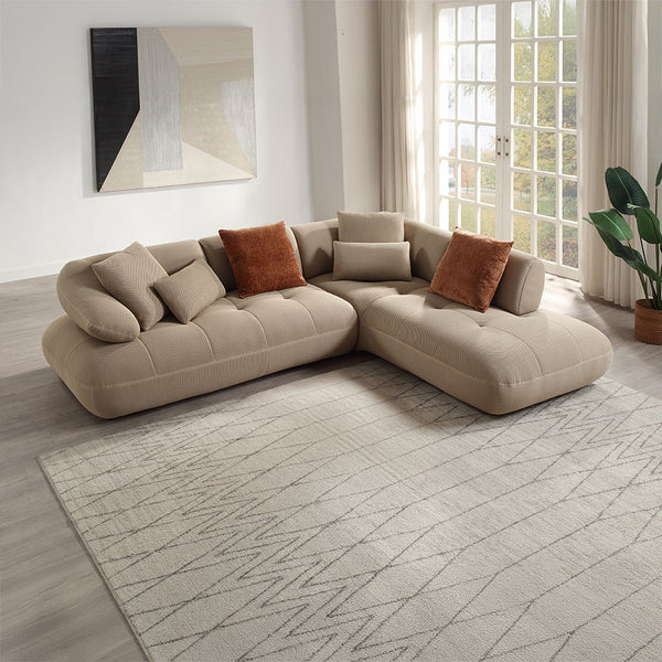 Discover unparalleled modern comfort with the Carrick sectional sofa. Draped in beige sandwich mesh fabric with a distinctive 3D texture, this sofa redefines luxury. The plush design and accompanying accent pillows enhance its inviting appeal, making it p