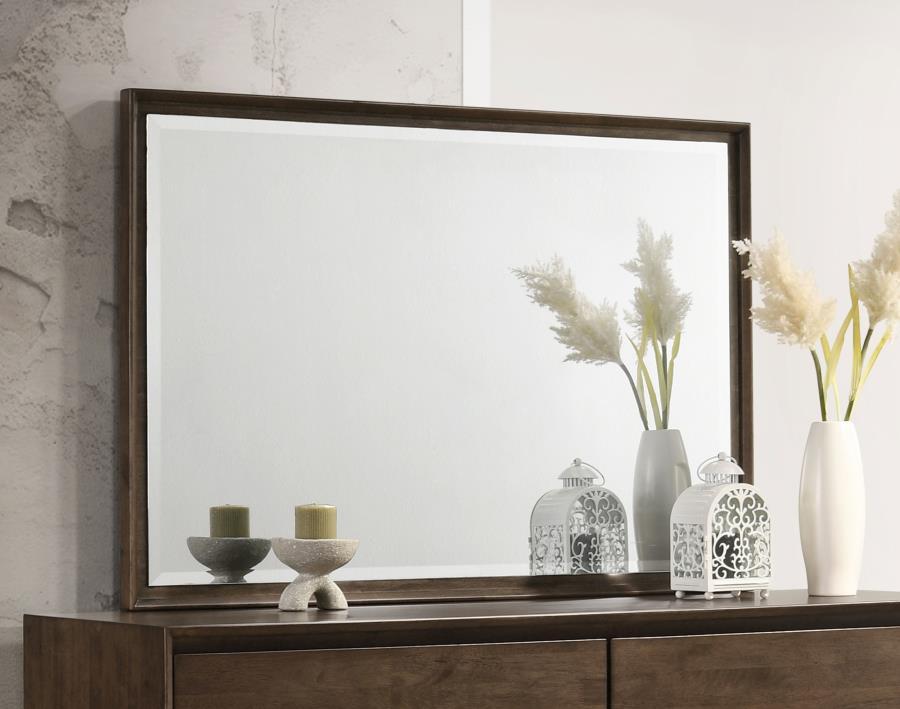 Augment your stylish dresser with a modern framed mirror. Perfect for the dresser top, it mounts directly and features a warm brown wood finish. The mirror boasts beveled glass for added depth, complementing its stylish reflectivity and depth. Mitered tri