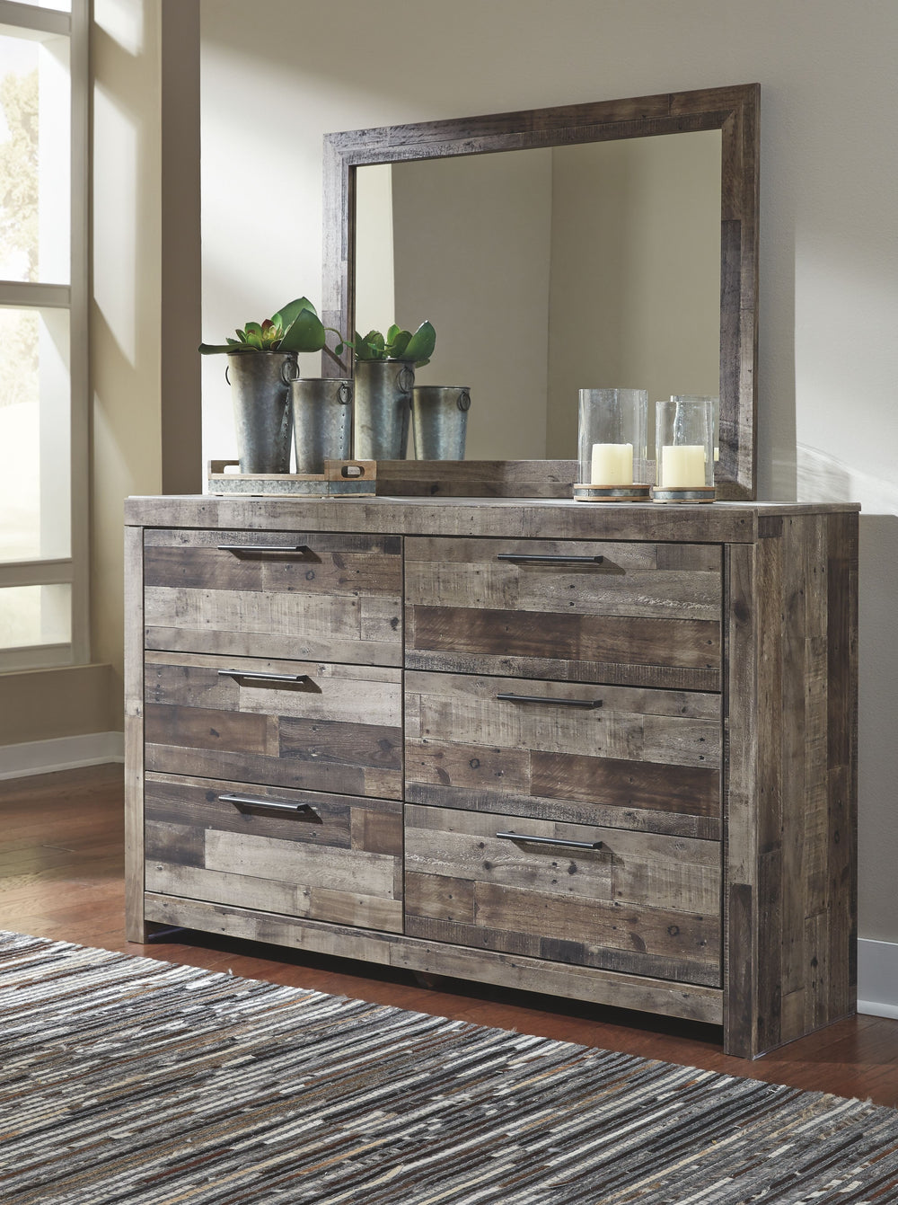 Modern yet hefty. This dresser and mirror set makes an urban eclectic statement. Seasoned raw wood look merges with the clean lined design we love today. Muted rustic finish over replicated pine grain maintains its authenticity. Roomy drawers are flanked 
