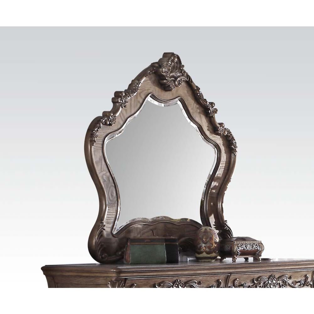 The Ragenardus mirror is an impeccable example of truly memorable luxurious traditional design. This vintage oak mirror features an arched frame with intricate floral design and beveled mirror. This piece is sure to bring a classy and traditional style to