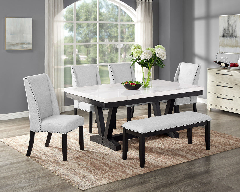 A fresh take on a traditional silhouette makes this group a great addition to your dining space. A genuine marble top is luxurious and timeless. The trestle base is updated in a contemporary charcoal finish. The upholstered dining chairs feature gently sl