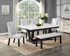 A fresh take on a traditional silhouette makes this group a great addition to your dining space. A genuine marble top is luxurious and timeless. The trestle base is updated in a contemporary charcoal finish. The upholstered dining chairs feature gently sl
