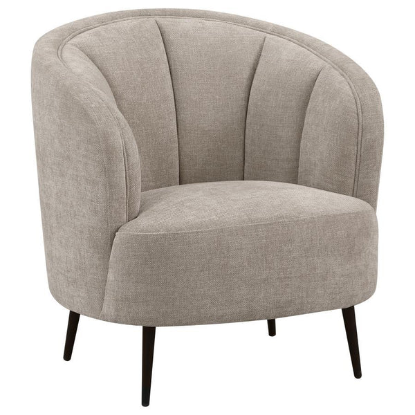 Show off your curve appeal with a modern upholstered accent chair, a great piece to float in the center of a room for an attractive focal point. The soft beige upholstery, with its velvety texture and extra wide channel details frame, creates a refined bu