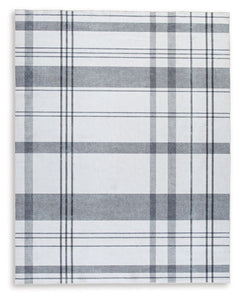 A fresh take on iconic plaid, this accent rug is both classic and contemporary. Its plaid design, with shades of gray crisscrossing against a solid cream background, has subtle variations that offer an artisanal feel. In addition, the machine woven materi