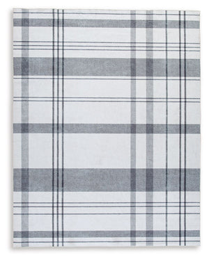 A fresh take on iconic plaid, this accent rug is both classic and contemporary. Its plaid design, with shades of gray crisscrossing against a solid cream background, has subtle variations that offer an artisanal feel. In addition, the machine woven materi
