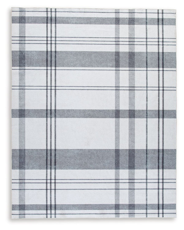 A fresh take on iconic plaid, this accent rug is both classic and contemporary. Its plaid design, with shades of gray crisscrossing against a solid cream background, has subtle variations that offer an artisanal feel. In addition, the machine woven materi