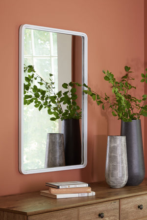 the simple shape of this mirror is given depth and dimension with the addition of a thick metal frame. A simple white finish gives it the perfect modern appeal. This piece is just right in a hallway