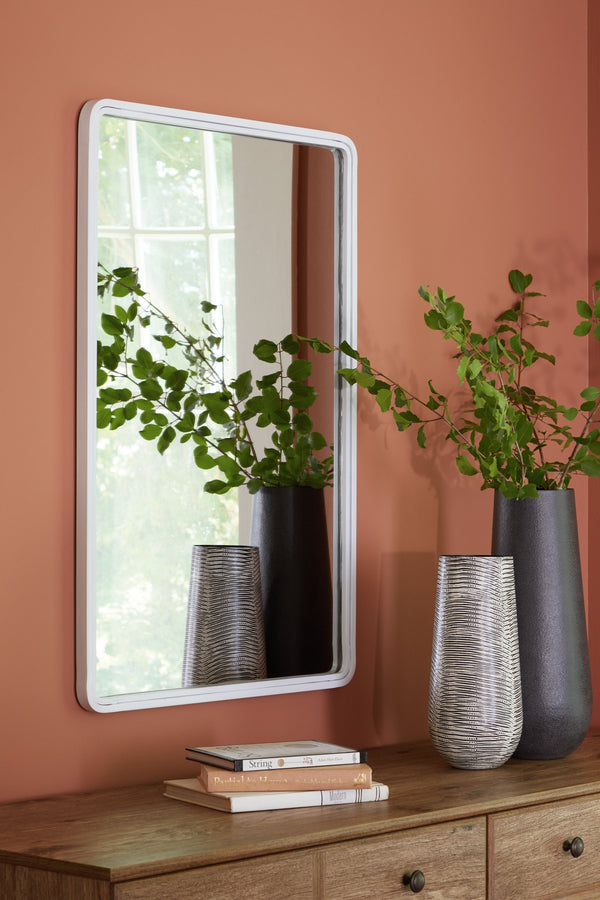  the simple shape of this mirror is given depth and dimension with the addition of a thick metal frame. A simple white finish gives it the perfect modern appeal. This piece is just right in a hallway
