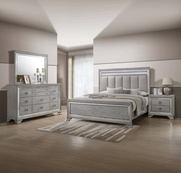 This elegant bedroom suite combines timeless design with contemporary appeal. The soft gray finish offers a modern twist on classic styling, with integrated LED lighting on the tufted headboard adding a luxurious focal point. The collection includes a bed