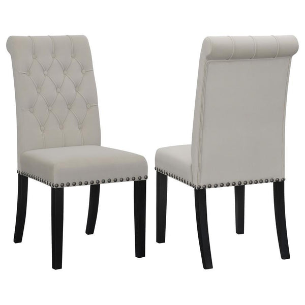 Blending timeless elegance with plush comfort, this side chair enhances any dining space. Its high backrest features a classic button-tufted design, adding depth and sophistication. A rolled top and hand-applied nailhead trim create refined detailing, whi