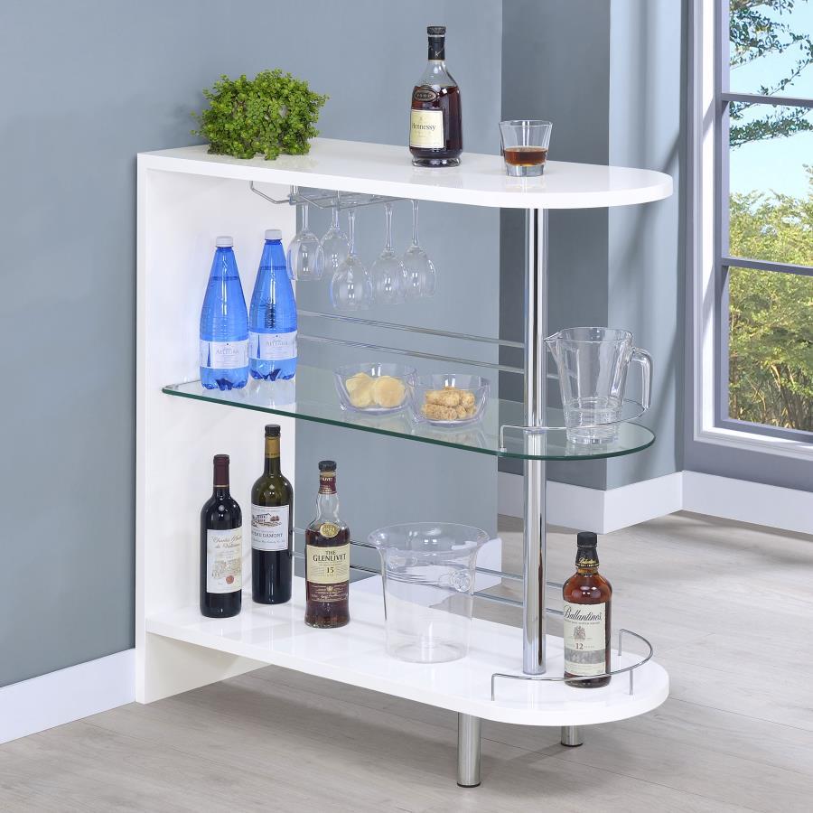 Liven up your next gathering with this attractive, contemporary bar unit. With a sleek design and a smooth, glossy white finish, it has a modern and glamorous look. Two tempered glass shelves provide lots of space for storage, while a built-in stemware ra