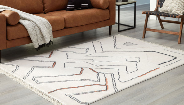  this accent rug features a modern abstract design that will warm your living space. Freeform lines with a knotted tassel edge elevate the look