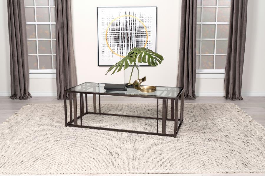This modern rectangular coffee table features a clear tempered glass top paired with a geometric base made from heavy-gauge metal with a sleek electroplated finish. The open design offers a contemporary aesthetic, blending elegance with durability. Perfec
