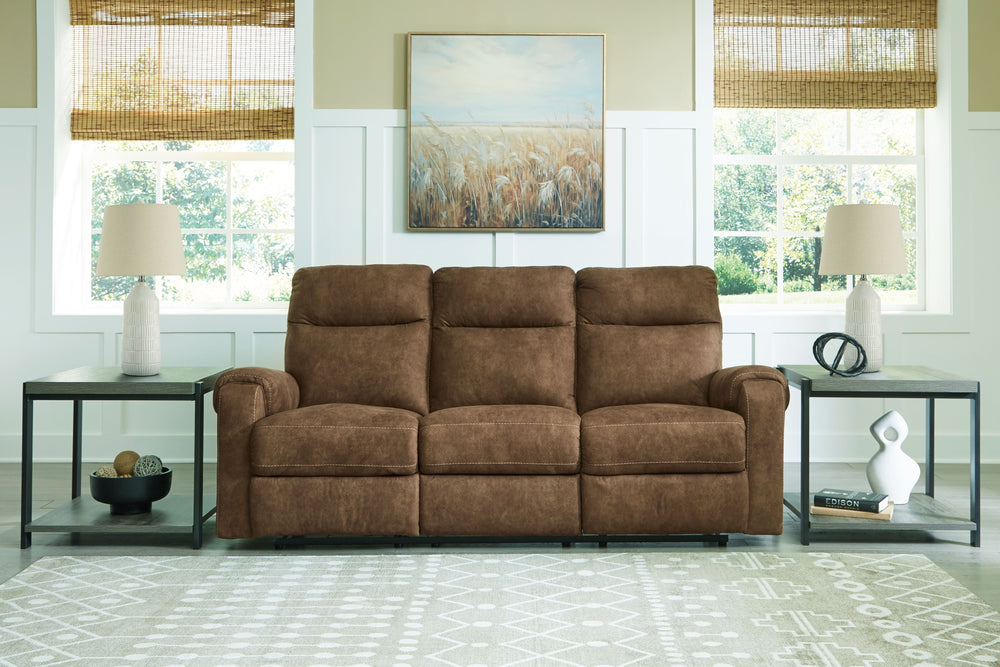 This reclining sofa is your best shot for comfort and total relaxation. Its super soft faux leather, contemporary bustle back and contrast stitching team up for a big win with most any color scheme and room decor. With the pull tab reclining motion, you-'