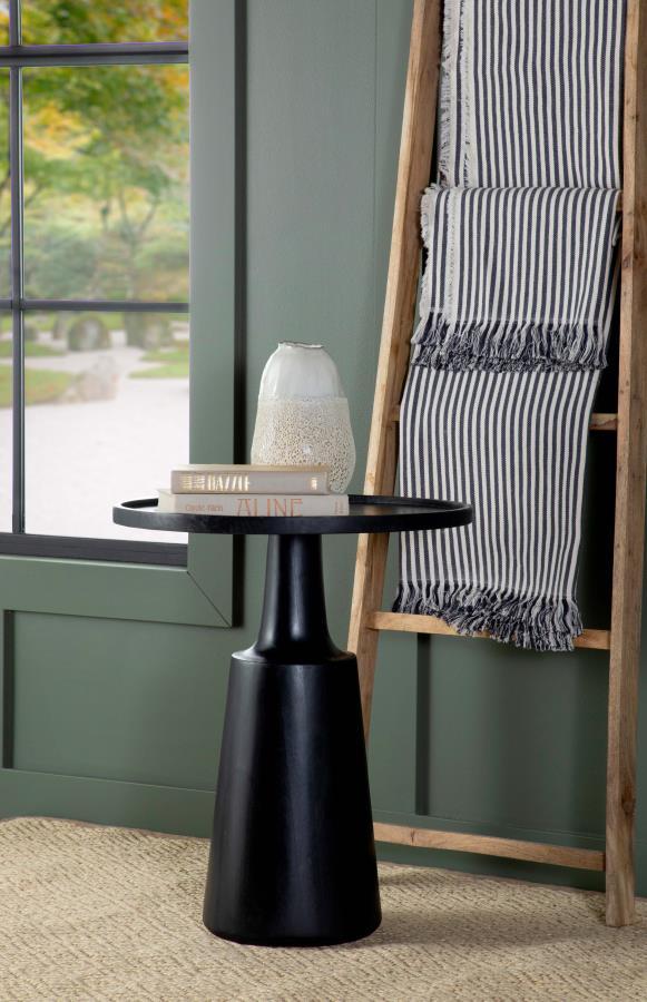  solid contoured base tapers toward the top that supports a round table surface. Raised edges define the silhouette even further and keep items in place. Made of an