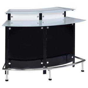 Entertain in sleek sophistication with this modern home bar, featuring a curved silhouette, chrome accents, and glossy black and white acrylic panels. Dual-tiered frosted glass tops offer ample space for mixing and serving, while the metal footrest invite