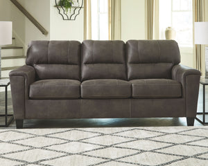  you can take comfort in this sofa. Wrapped in a fabulous faux leather with a weathered hue and hint of pebbly texture to resemble the real deal