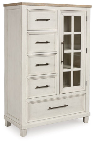 This door chest elevates the art of modern farmhouse design. Its two-tone aesthetic blends antiqued white and light grayish brown for a charming finish. Framed drawer fronts and a windowpane door lend a country feel. Conveying a feeling of relaxed comfort