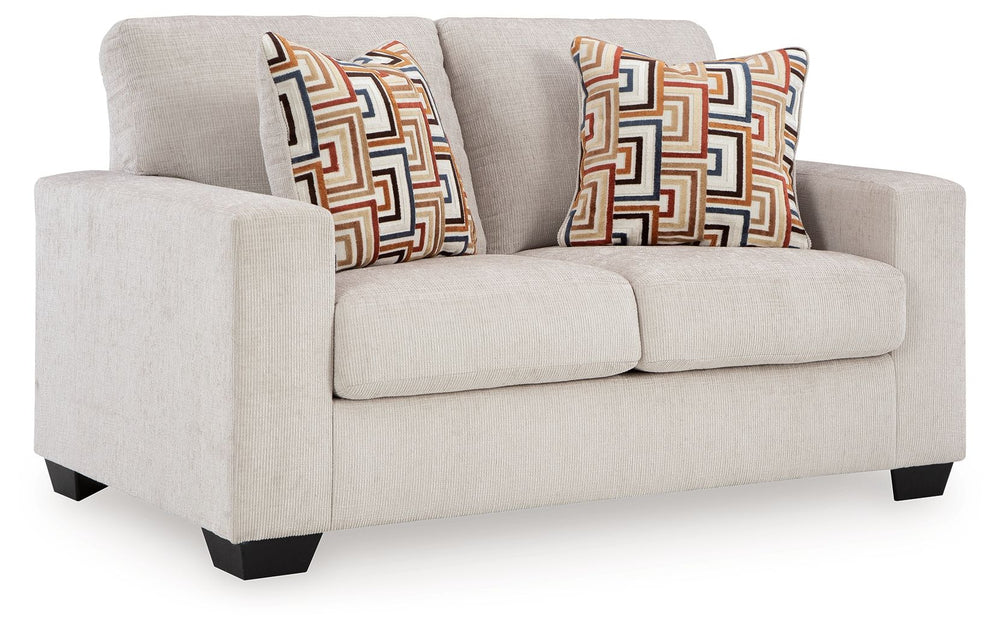 Looking to make a simply chic statement with color? Liven up your living room with this loveseat. Its trend-right light neutral upholstery is a perfect blank canvas for adding pops of color. Bold and eclectic accent pillows complete the look. Pairing posh