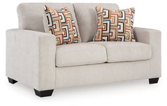 Looking to make a simply chic statement with color? Liven up your living room with this loveseat. Its trend-right light neutral upholstery is a perfect blank canvas for adding pops of color. Bold and eclectic accent pillows complete the look. Pairing posh