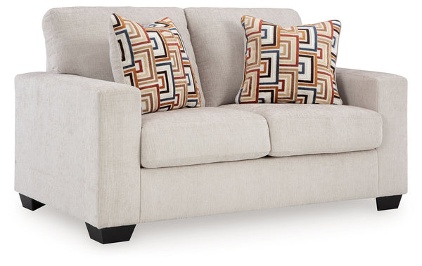 Looking to make a simply chic statement with color? Liven up your living room with this loveseat. Its trend-right light neutral upholstery is a perfect blank canvas for adding pops of color. Bold and eclectic accent pillows complete the look. Pairing posh