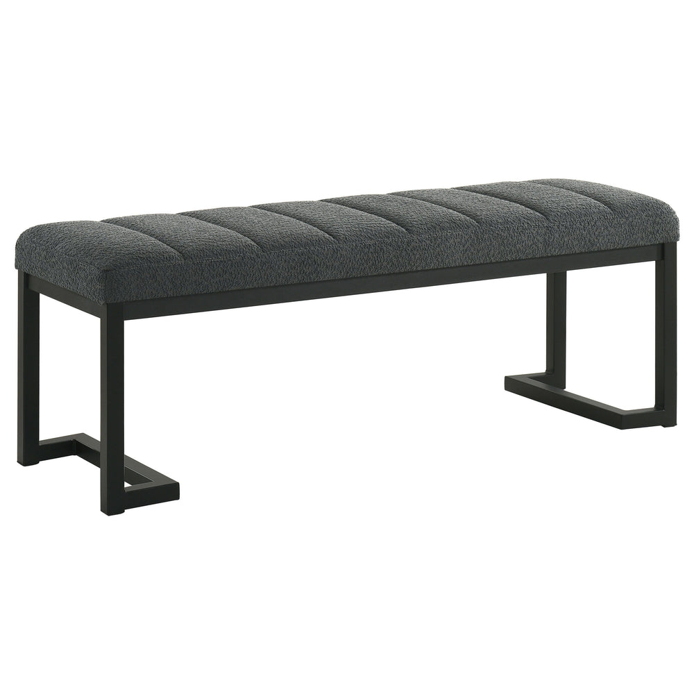 Textured upholstery plays perfectly with the modern silhouette of a backless accent bench. Its deep black finished frame is constructed in metal for excellent durability, with a bracket inspired silhouette that emphasizes its contemporary design credentia