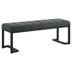 Textured upholstery plays perfectly with the modern silhouette of a backless accent bench. Its deep black finished frame is constructed in metal for excellent durability, with a bracket inspired silhouette that emphasizes its contemporary design credentia