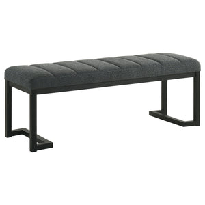 Textured upholstery plays perfectly with the modern silhouette of a backless accent bench. Its deep black finished frame is constructed in metal for excellent durability, with a bracket inspired silhouette that emphasizes its contemporary design credentia