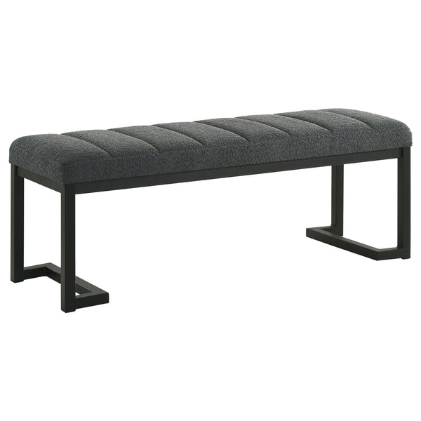 Textured upholstery plays perfectly with the modern silhouette of a backless accent bench. Its deep black finished frame is constructed in metal for excellent durability, with a bracket inspired silhouette that emphasizes its contemporary design credentia