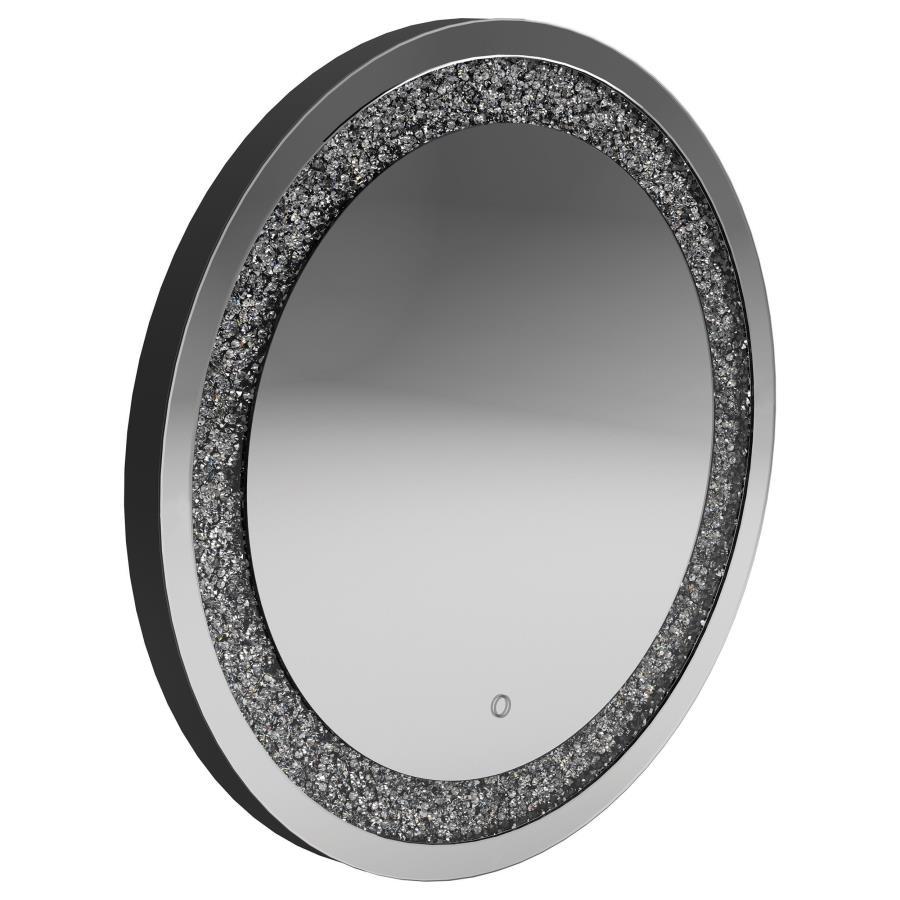 Add a glamorous glow to your space with this round LED wall mirror. Surrounded by a dazzling silver frame with embedded crystal-like accents, it blends modern style with everyday function. The integrated LED lighting provides soft illumination, making it 