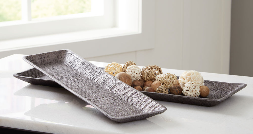 Top off tables and counters with this tray set. Searching for a casually cool catch-all option for your entryway? They keep keys and other essentials corralled. Also acting as a beautiful base for additional decorative pieces thanks to their textured surf