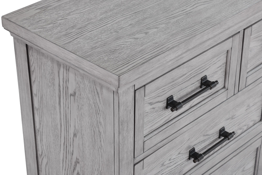 This bedroom suite offers a refreshing take on rustic charm, featuring a soft greige finish that highlights the natural wood grain. The sturdy bed stands as the centerpiece with its robust headboard and inviting design, while the accompanying pieces â€” a