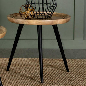  the round tabletop showcases natural wood grain patterns and a softly curved edge with carved detailing for added elegance. It
