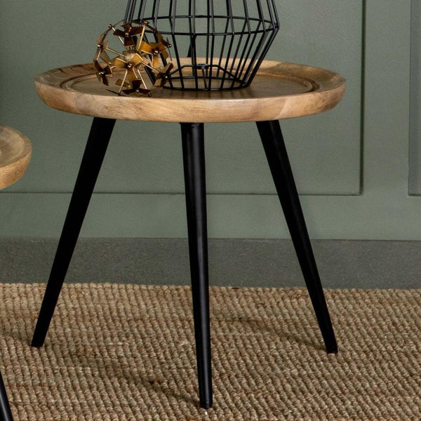  the round tabletop showcases natural wood grain patterns and a softly curved edge with carved detailing for added elegance. It
