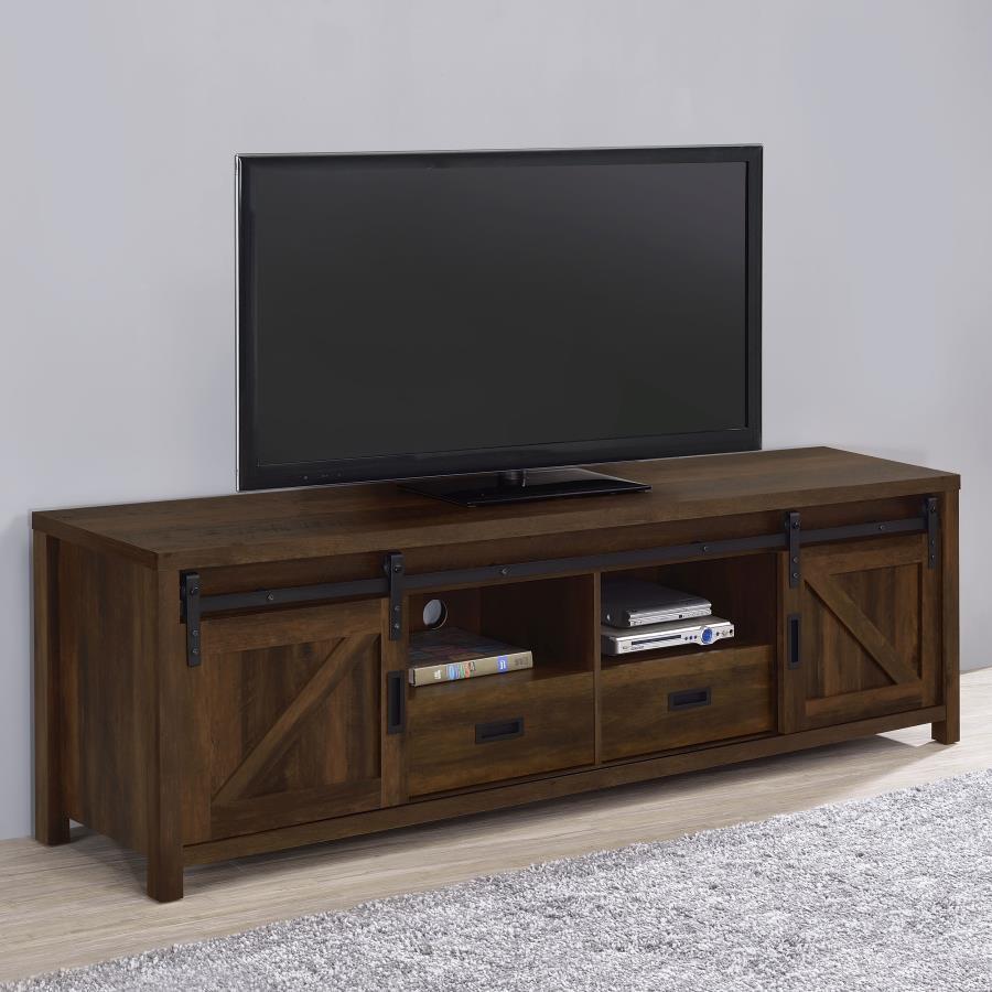 Wood-like finishes and country-inspired elements create this rustic style TV console. Keep entertainment consoles, a stereo and more tucked neatly within two open shelves toward the center. Disguised by sliding barn doors mounted on black hardware that le