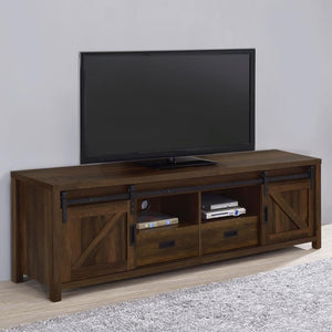  a stereo and more tucked neatly within two open shelves toward the center. Disguised by sliding barn doors mounted on black hardware that le