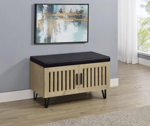  featuring a faux leather upholstered padded top for added versatility as a seating bench. The cabinetâ€™s two doors showcase a vertical slat design