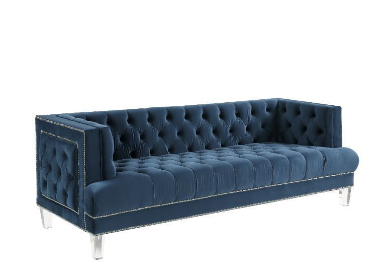 Sophistication meets modern with the Ansario living room collection. The rich blue velvet adds character to any room. Showcasing a square back, high arms, and nail-head trim, feature button tufted accents. The acrylic legs give off a modern vibe to the pi