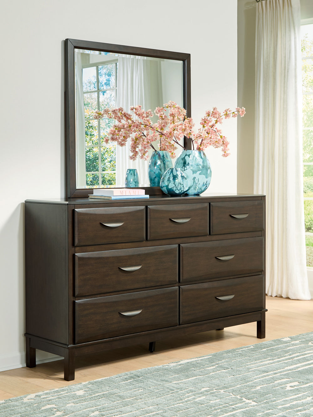 A rich, metropolitan finish. Unbeatable function. With this dresser and mirror, itâ€™s a breeze to create a casual contemporary hideaway full of style and convenience. It combines thoughtful craftsmanship and handy storage, with smooth-gliding drawers to 