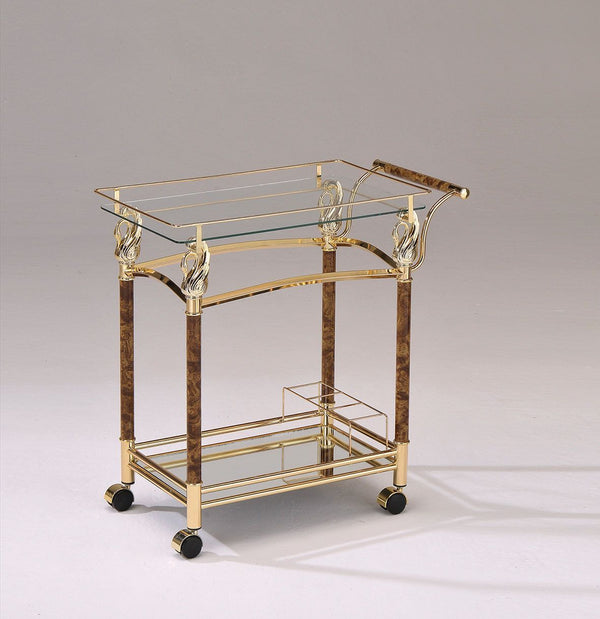 Keep your life glamorous and on the go with the Helmut Serving Cart. This rolling bar cart features a gold-plated frame that shows off its shimmering glass and mirrored shelves. The two-tier shelves create a multipurpose drink tray or nightstand with room