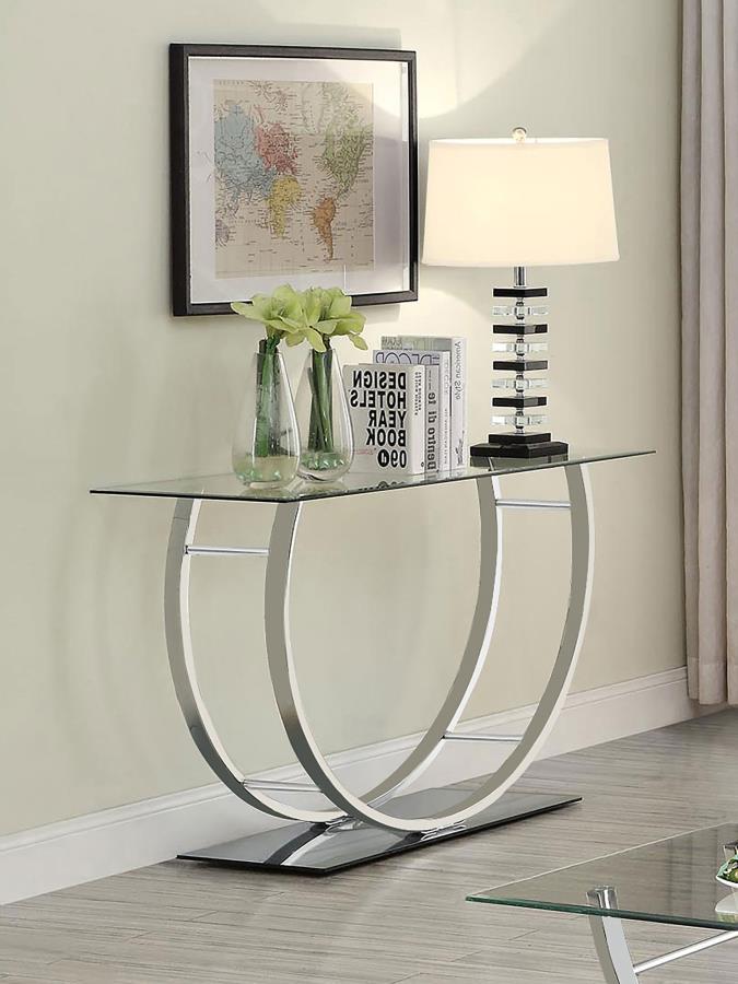 This modern rectangular console table showcases a clear tempered glass top paired with a sleek mirrored base, creating a polished, contemporary appeal. The curved frame, crafted from heavy gauge electroplated chrome metal, adds a touch of sophistication a