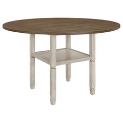 Uniquely fashionable and supremely functional, this counter height dining table has it all. Perfect for spontaneously switching up your style, the square tabletop features four drop down leaves to convert it to a round shape. An open shelf is built into t