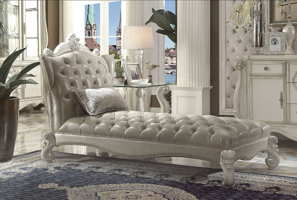 Create an elegant, traditional design in your room with the Versailles Chaise. A hand-crafted piece inspired from the luxurious designs of the past, this stunning piece comes in a bone white finish and features a vintage gray PU button-tufted back and sea