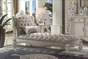 Create an elegant, traditional design in your room with the Versailles Chaise. A hand-crafted piece inspired from the luxurious designs of the past, this stunning piece comes in a bone white finish and features a vintage gray PU button-tufted back and sea