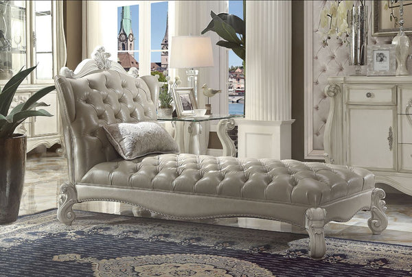 Create an elegant, traditional design in your room with the Versailles Chaise. A hand-crafted piece inspired from the luxurious designs of the past, this stunning piece comes in a bone white finish and features a vintage gray PU button-tufted back and sea