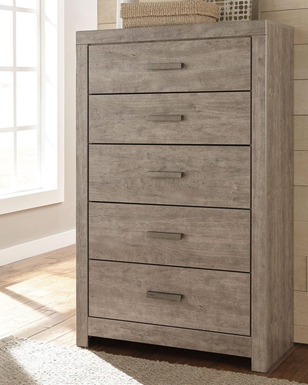This chest-'s weathered driftwood finish evokes such an ethereal vibeâ€”exactly what you need for your serene master suite. Clean lines and simple yet substantial hardware make for a timeless look youâ€™ll love living with for years to come. Five spacious